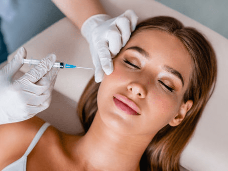 A woman getting an injection in her face.