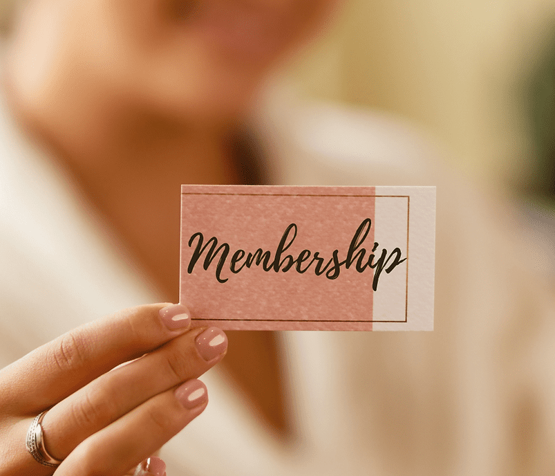 A person holding up a card that says membership.