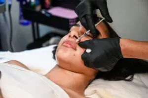 A person getting their face waxed at the salon