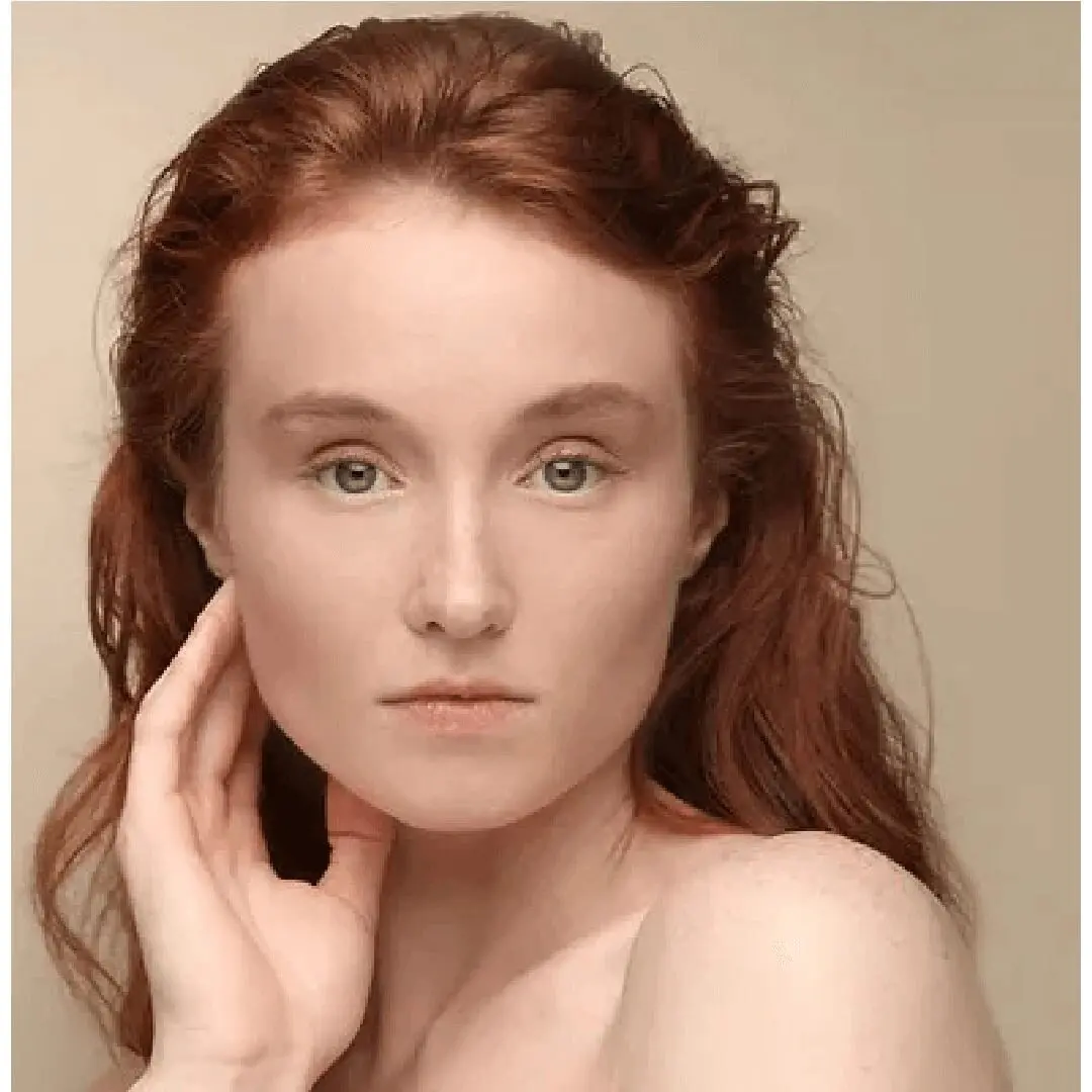 A woman with red hair and bare shoulders.