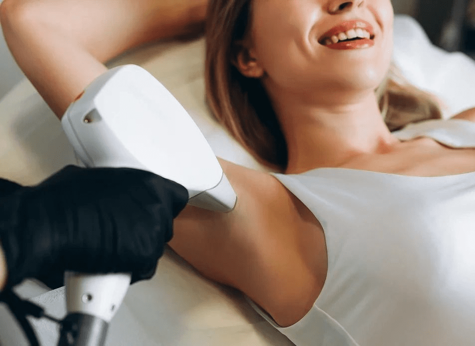 A woman is getting her arms and legs shaved.