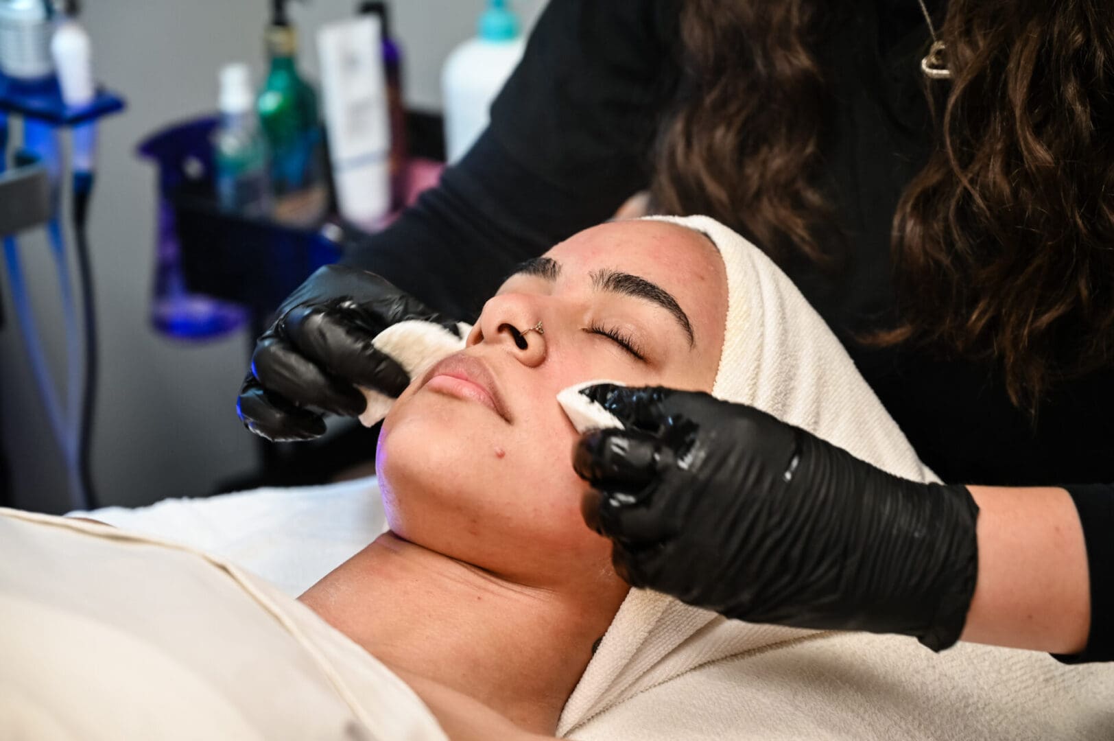 A woman getting her face waxed at the spa