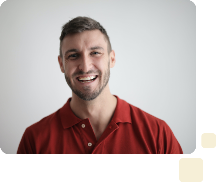 A man in red shirt smiling for the camera.