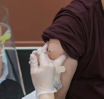 A person getting their arm shaved with an electric razor.