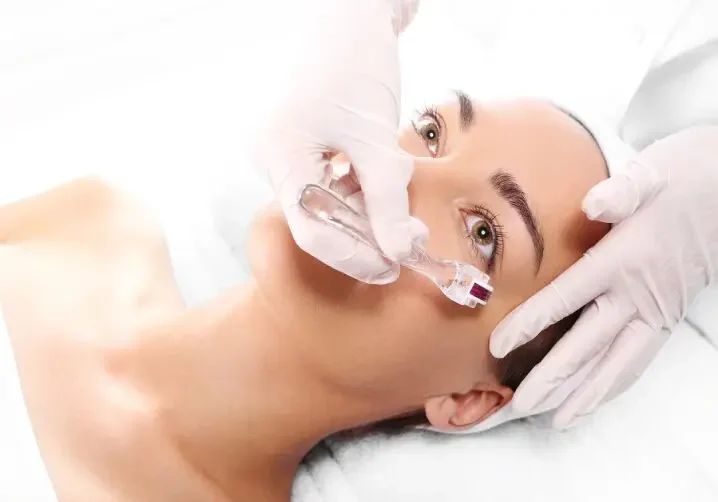 A woman getting her face waxed at the spa